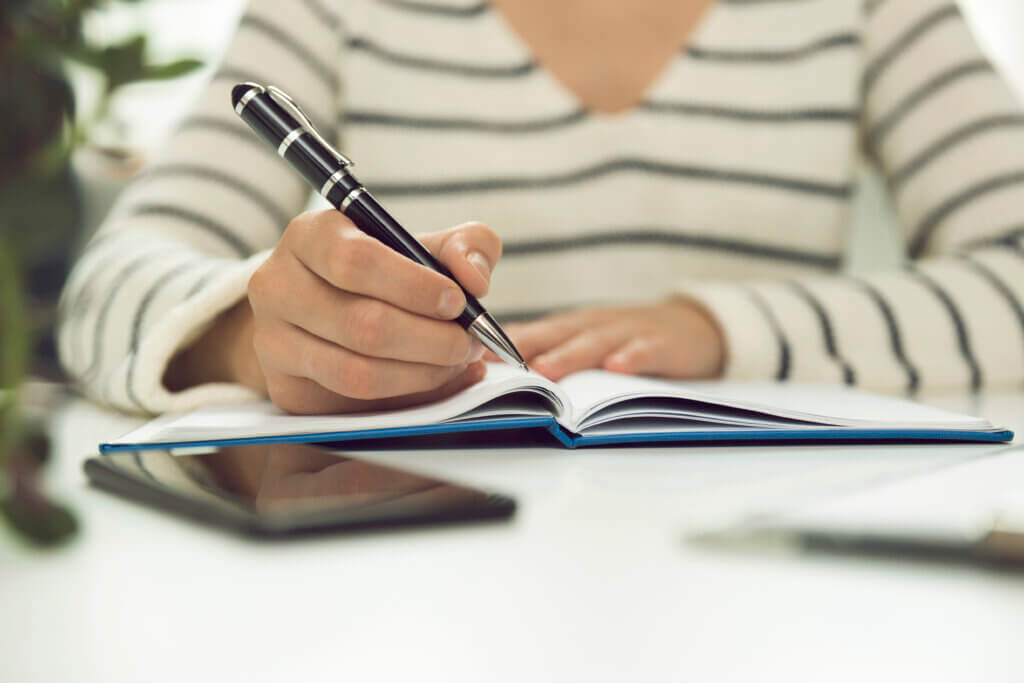 a woman writing down her career vision