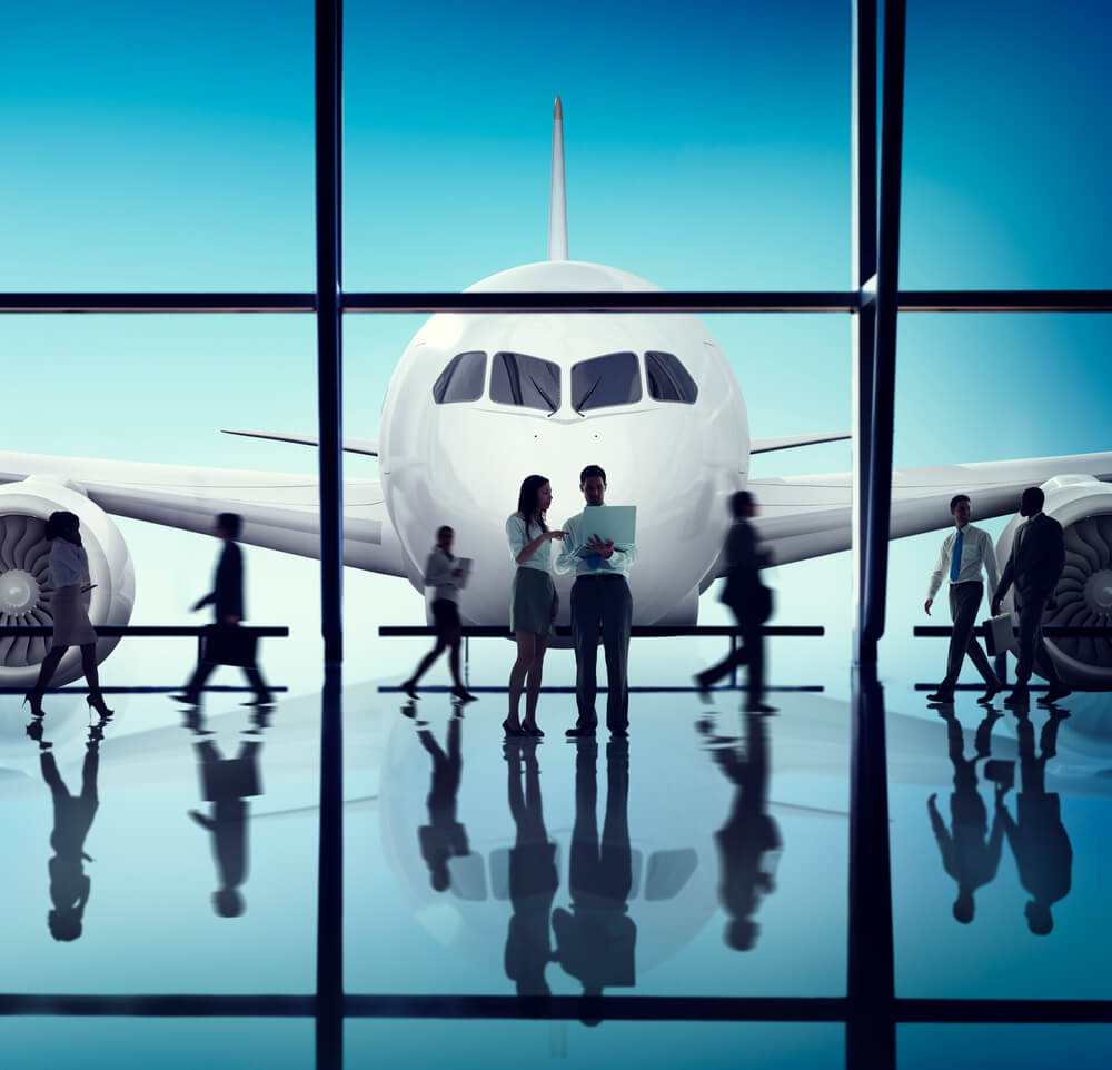 a man and a woman standing in the airport having some discussion